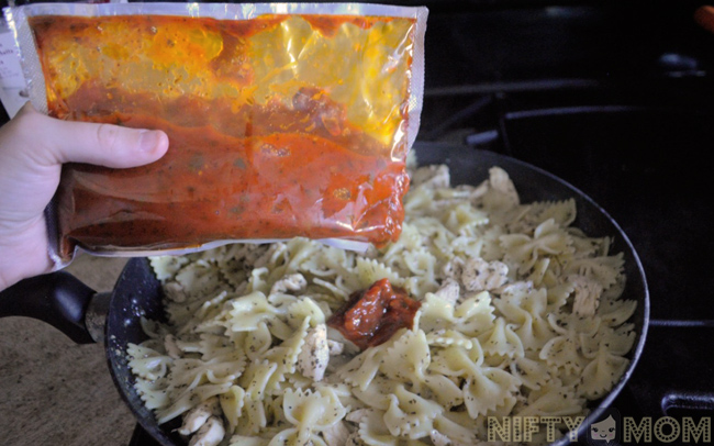 Adding Finishing Sauce on Chicken Bruschetta Pasta