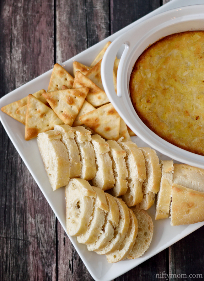 Hot Artichoke Dip served with sliced baguettes and Pita crackers