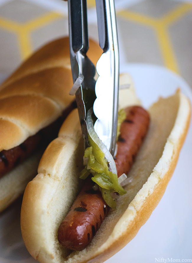 Adding Grilled Peppers and Onions to Hot Dogs